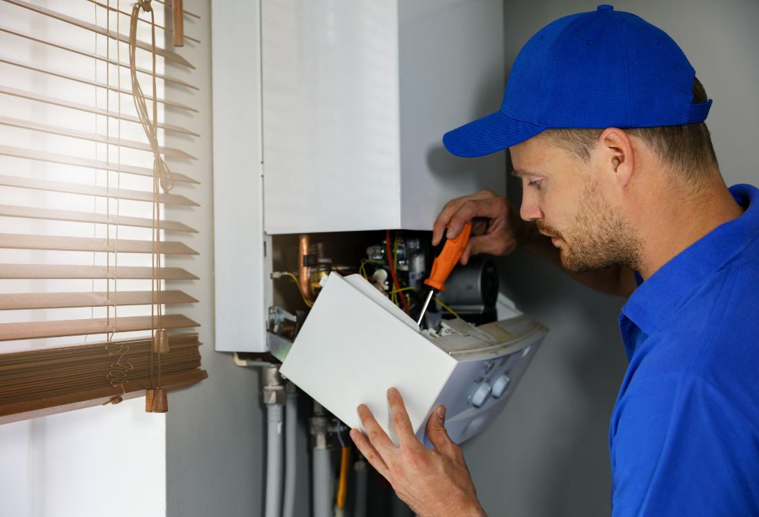 A technician carrying out a regular service on a homeowners’ boiler which helps to prevent a multitude of issues, highlighting why boiler service and maintenance is important.  