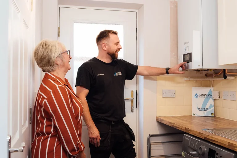 Nicholson Heating Services team with customer